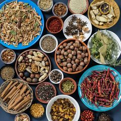 Set of spices and nuts: lemon grass, cinnamon, pepper, paprika, anise, rosemary, laurel leaf, ginger, hazel-nut, walnut, almond, coriander, banyan.