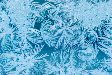 New Year and Christmas abstract icy frost cold weather snowy blue background with real ice crystals...