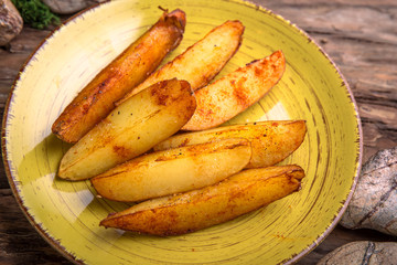 Homemade fried potatoes with mushrooms, paprika and greens.