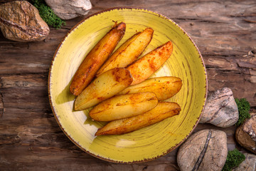 Homemade fried potatoes with mushrooms, paprika and greens.
