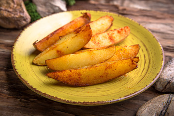Homemade fried potatoes with mushrooms, paprika and greens.