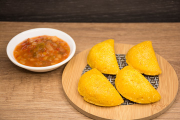 Colombian empanada with spicy sauce