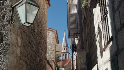 Street of the old town with a view of the bell tower