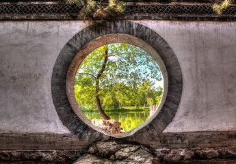Looking through a circular doorway to a lake at Bishushanzhuang Imperial Mountain Resort.
