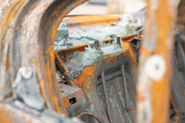 car after deliberate arson. destroyed vehicle after a fire melted is on the street.