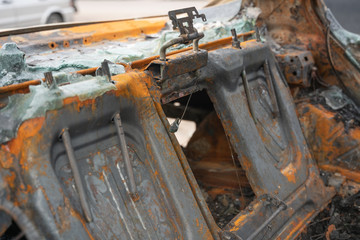 car after deliberate arson. destroyed vehicle after a fire melted is on the street.