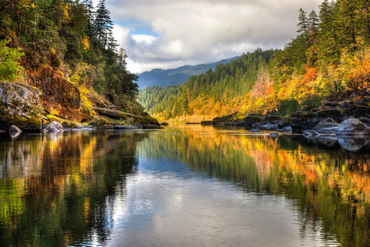 A rainbow of fall colors is reflected in the smooth Rogue River while white water rafting with some amazing friends