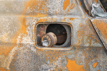 crushed melt car after deliberate arson. destroyed vehicle after a fire melted is on the street.