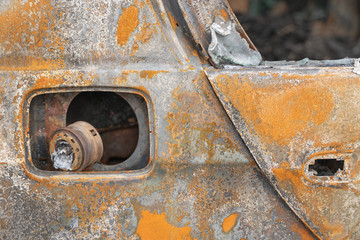 car after deliberate arson. destroyed vehicle after a fire melted is on the street.