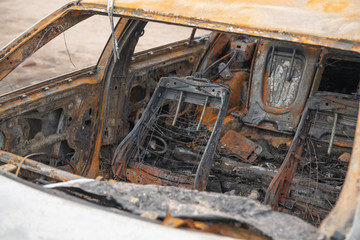 Fototapeta premium car after deliberate arson. destroyed vehicle after a fire melted is on the street.