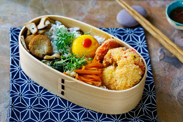 Japanese bento box with tempura prawns, rice and vegetables
