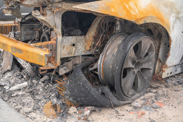 Fototapeta premium car after deliberate arson. destroyed vehicle after a fire melted is on the street.