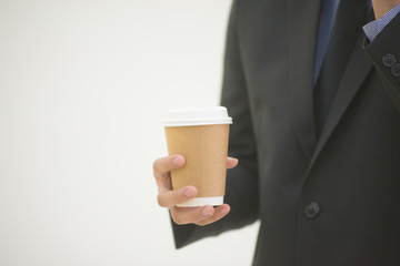Attractive businessman holding a coffee cup