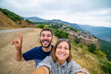 happy tourist backpacker take selfie photo in front of the monastery of Armenia, Caucasus region