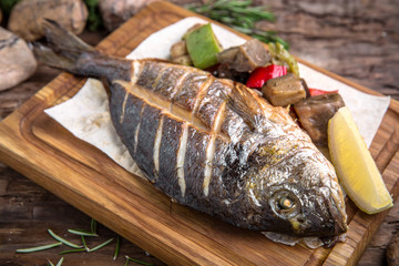 Grilled dorado fish with grilled vegetables. Beautiful stylish menu.  Free space for text