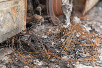 crushed melt car after deliberate arson. destroyed vehicle after a fire melted is on the street.