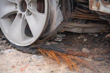 car after deliberate arson. destroyed vehicle after a fire melted is on the street.