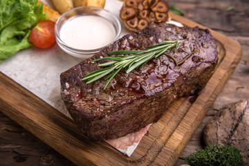 Neck steak, tenderloin or filet mignon pork or beef. Juicy tasty piece of meat. Delicious juicy steak.  A big piece of grilled meat.