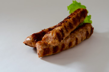 smoked sausage against the white background with salad