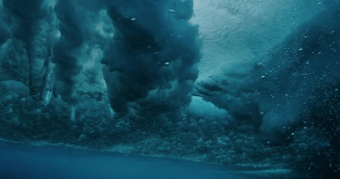 Underwater shot of amazing bubble vortex rings forming on the back of a breaking wave with turbulence, marvels of nature