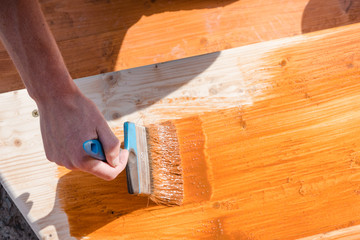 Paint the porch with orange paint. Decorate the terrace. Paint the boards with a wide brush. To...