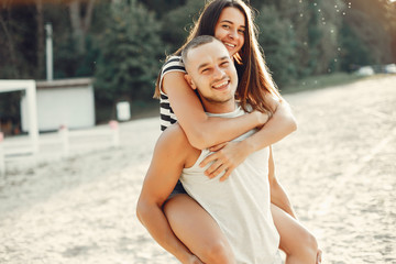 Couple in a park. Woman in a t-shirt. Man with his wife