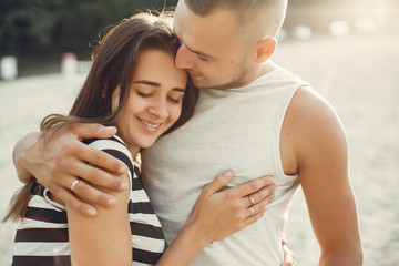 Couple in a park. Woman in a t-shirt. Man with his wife