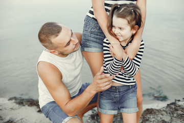 Fototapeta premium Family in a summer park. Mother and little daughter playing. Cute little girl with a father
