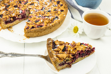 Homemade cake with honeysuckle berries and streisel. Delicious Breakfast with berry pie and tea....