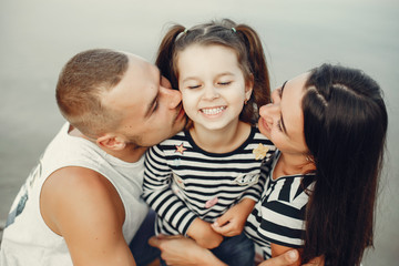 Family in a summer park. Mother and little daughter playing. Cute little girl with a father