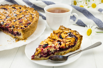 Homemade cake with honeysuckle berries and streisel. Delicious Breakfast with berry pie and tea....