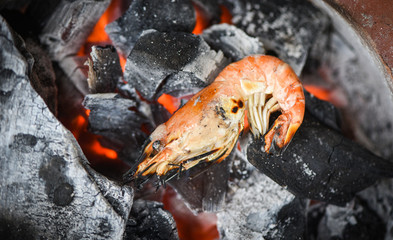 shrimp grilled bbq seafood on charcoal - prawns shrimps cooked burnt