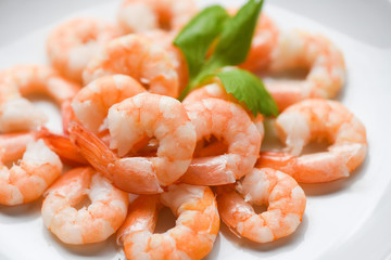 fresh shrimps served on plate - boiled peeled shrimp prawns cooked in the seafood restaurant