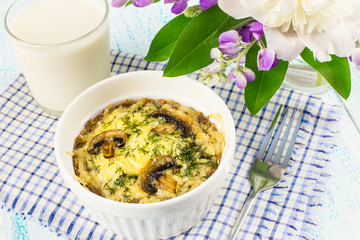 Delicious buckwheat casserole with mushrooms and cheese. Health food. Healthy Breakfast of buckwheat and milk.