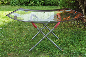 New car windshield resting on a portable metal stand