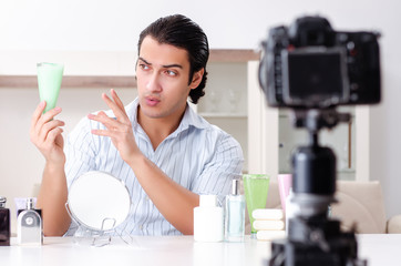 Young handsome man recording his blog in hygiene concept