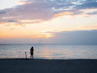 Obraz premium A man is standing alone, contempling the beautiful sunset in Miami beach, Florida, USA