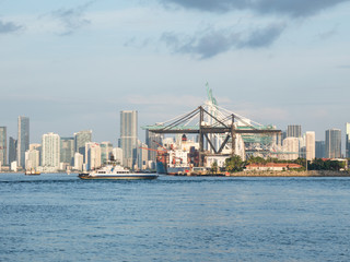 Naklejka premium Panorama of Miami Port, Fisher Island and downtown, colorful city light and Biscayne Bay water