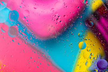 Micro molecular abstract pattern of colored oil bubbles on water. 