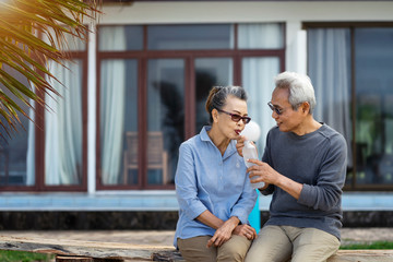 Senior couple sitting on chairs on the beach and looking at the ocean in a romantic,Elderly life...