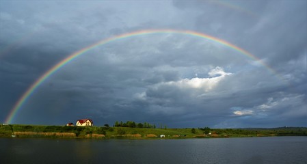 Fototapeta na wymiar a rainbow over the lake