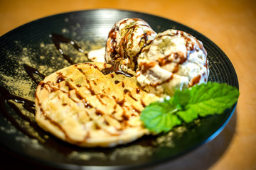 Matcha green tea topping on ice cream with waffle and Chocolate 