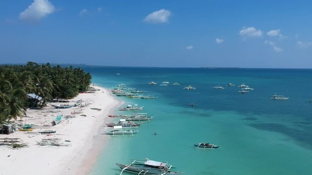 A picture perfect aerial shot of fishing boats along one of the beautiful white sand beaches of Bantayan Island, Cebu Province, the Philippines.