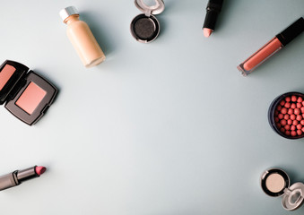 Beauty background for makeup cosmetic product on pastel light blue desktop background. top view, flat lay.