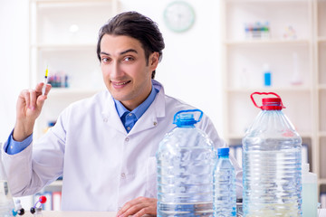 Young male chemist experimenting in lab