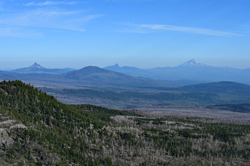 View of High Cascades volcanoes from Tam McArthur Rim Trail in Three Sisters Wilderness near Sisters, Oregon on a clear summer morning.