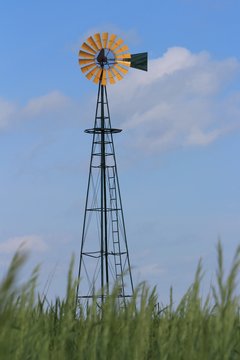 windmill against blue sky in Kansas out in the country.