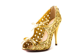Golden high heel fashion shoe on background