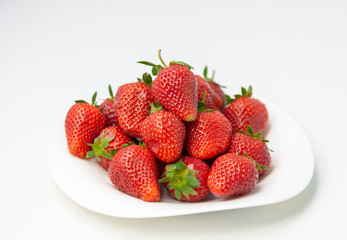 Red fresh strawberry on plate isolated on white background
