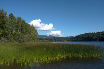 Three clouds at mountain lake
